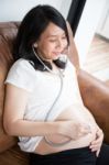 Pregnant Woman Using Stethoscope Stock Photo