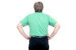 Back Pose Of Elderly Guy With Hands On His Waist Stock Photo