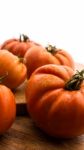 Freshly Picked Tomatoes, Place On Wooden Chopping Board And Table Stock Photo