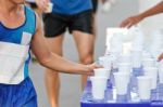 Marathon Racer Catching Cup Of Water Stock Photo