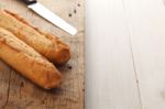 Baguette Bread On Rustic White Wooden Background Stock Photo