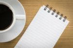 Coffee And Notepad On Wood Table Stock Photo