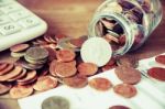 Coins Spilling Out Of A Glass Bottle Vintage Stock Photo