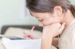 Asian Girl Writing On Lesson Book Stock Photo