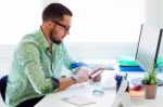 Handsome Businessman Using Mobile Phone In Office Stock Photo