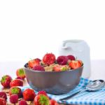 Bran Flakes With Fresh Raspberries And Strawberries And Pitcher Stock Photo