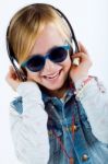 Beautiful Child Listening To Music With Digital Tablet Stock Photo