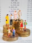 Miniature Family Stand On Pile Of Euro Coins And Book Bank. Fami Stock Photo