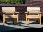 Two Wooden Chairs By The River Thames Available For Weary Touris Stock Photo