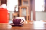 Purple Coffee Cup On Wooden Table Stock Photo