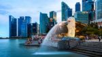 Merlion Statue And Cityscape In Singapore Stock Photo