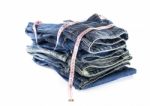 Heap Of Jeans Trousers With Tape Measure Stock Photo