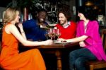 Friends Enjoying Dinner At A Restaurant Stock Photo