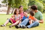 Happy Family Having Fun In The Park Stock Photo