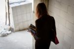 A Businesswoman Holds A Calculator While Walking Down A Stairwel Stock Photo