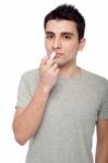 Young Man Applying Lip Balm Stock Photo