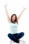 Woman With Hands Up Sitting In Crossed Legs Stock Photo