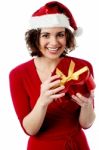 Excited Female Santa Opening Gift Box Stock Photo