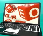 Seo Dice On Laptop Showing Online Web Optimization Stock Photo