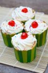 Delicious Cupcakes On The Wooden Floor Stock Photo