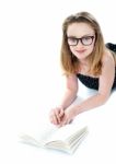 Smiling Girl Lying With Opened Book Stock Photo