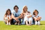 Happy Family Relaxing In Garden Stock Photo