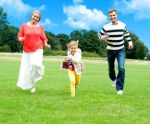 Family Running In Outdoor Stock Photo