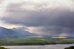 Town On The Lake Behind The Foothills. Spring Rain And Storm In Stock Photo