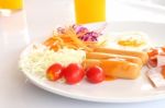 Breakfast Meal And Salad On Morning Table Stock Photo