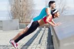 Young Couple Doing Push-ups Stock Photo