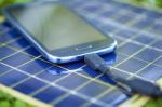 Charging Smart-phone With Solar Charger Stock Photo