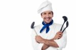 Smiling Chef Holding Kitchenware Stock Photo