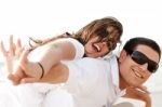 Young Couple Piggy Backing Stock Photo