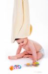 Baby With Towel On Is Head While Playing Toys Stock Photo