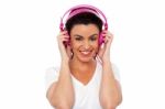 Smiling Woman Enjoying Music Stock Photo