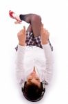 High Angle View Of Pointing Woman Lying Down On Floor Stock Photo