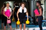 Happy Man And Woman Lifting Kettlebell Stock Photo