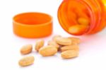 Closeup Of Orange Pills And Pill Bottle Stock Photo