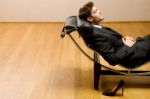 Man Lying On Chaise Longue Stock Photo