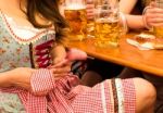 Beautiful Young Woman Fixing Her Dirndl At Munich Oktoberfest Stock Photo