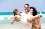 Family Enjoying On The Beach Stock Photo