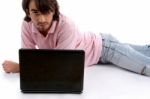 Lying Young Man With Laptop Stock Photo