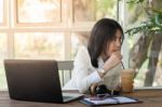 Young Businesswoman Working In Coffee Shop Stock Photo