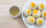 Chinese Pastry Mung Bean Or Mooncake With Egg Yolk On Dish Wooden Table And Green Tea Cup Stock Photo