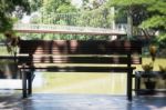 Wooden Bench In A Water House Garden Stock Photo