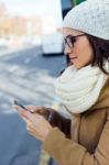 Young Beautiful Woman Using Her Mobile Phone On A  Bus Stock Photo