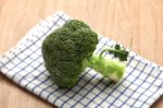 Broccoli On Wooden Table Stock Photo