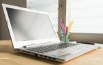 Laptop And Notebook And Pen On Wood Table Stock Photo