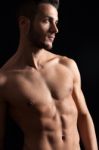 Shirtless Young Man Against Black Background Stock Photo