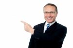 Smart Businessman Pointing Away Stock Photo